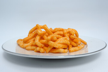 long, dry yellow snacks on a clean white background