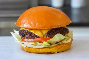 Burger beef cheese classic minimal close up. Hamburger freshly baked on white plate, homemade. Grocery product advertising, menu or package.