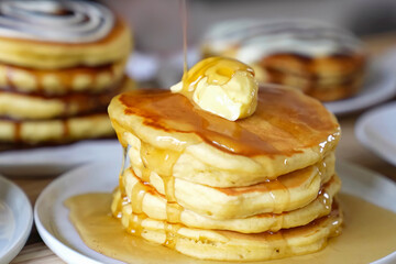 Pancakes fluffy stack on white plate, delicious food. Homemade freshly baked pancakes for American...