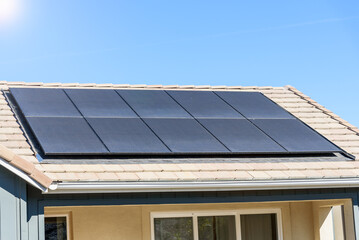 Solar panels covering the roof of a newly built energy efficient house in a suburban development on...