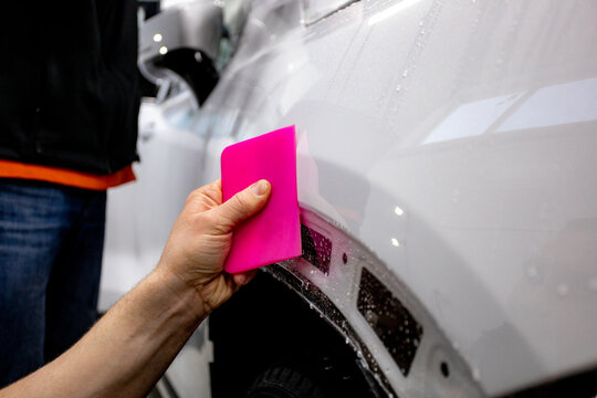 The process of installing PPF on a car. PPF is a protective film for paint that protects the paint from scratches and gravel.Anti-gravity protection. PFF is installed. Wrapping a car in close-up