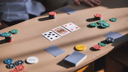 Young guys playing poker at a table.