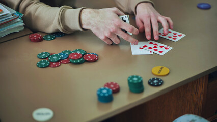 Young guys playing poker at a table.