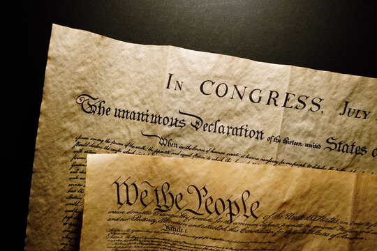 Pages of the United States Constitution showing We The People heading and Declaration of Independence