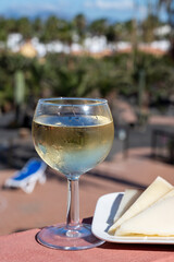 Glasses of cold white wine on roof terrace served outdoor in Corralejo, Fuerteventura in sunny day