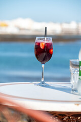 Glass of cold sangria wine served with orange in beach cafe, Corralejo, Fuerteventura, Spain