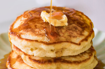 Pancakes fluffy stack on white plate, delicious food. Homemade freshly baked pancakes for American...