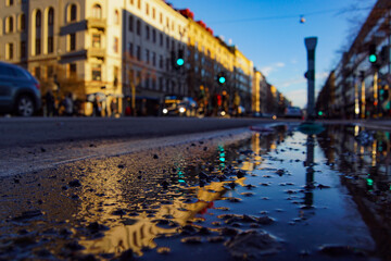 Fototapeta na wymiar Close-up of wet street in city during rainy season