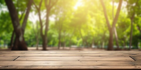 Blurred trees in nature park backdrop with a wood floor, displaying products for summer season.