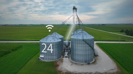 Agritech futuristic farm with silos. IoT connectivity and digital readouts. Farmer in USA selling corn at modern grain bin. 3D render © TechAnimationStock