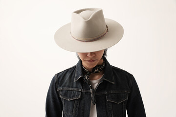 Handsome Asian man wearing hat looking away posing indoor. Isolated.