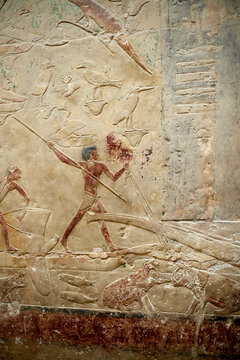 Wall carving from the mastaba of Idut from V Dynasty, showing a men fishing and hipopotamus hunting in the marshes, Saqqara, Egypt
