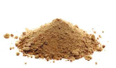 Unrefined brown cane sugar pile isolated on white