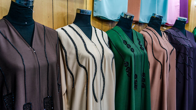 arabic women dress abaya for sale at a textile store in the souq faleh.