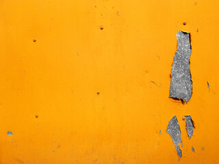 Steel texture metal sheet background with peeling yellow paint.