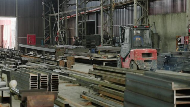 Capturing video in the production zone at metalwork factory the industrial truck carrying the heavy piece of metal