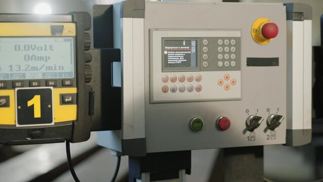 Manufacturing factory closeup the factory worker press the buttons on the panel control to stop the production line