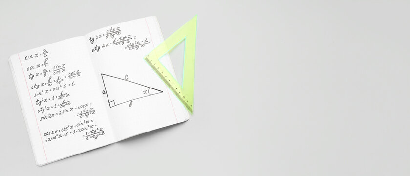 Copybook with maths formulas and ruler on grey background with space for text