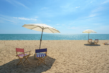 Fototapeta na wymiar Chair and Umbrella on a Tranquil Beach