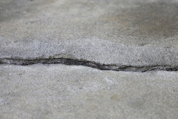 Fototapeta na wymiar Home building problem. Cracked concrete floor, broken building structure