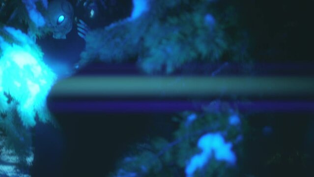 Man shining a flashlight at scared alien trying to hide among trees in the forest at night