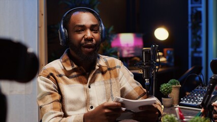 Man on podcast using recording camera while talking with guest during marathon streaming live broadcast for good humanitarian cause, gathering donations from viewers, filming with professional gear