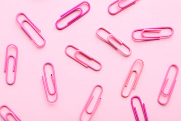 Set of paperclips on pink background