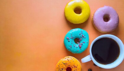 Delicious breakfast with donuts and coffee. Vivid orange background with copy space - obrazy, fototapety, plakaty