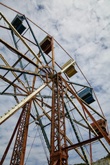 Abandoned Ferris Wheel, Rust and Decay, Against Partly Cloudy Sky