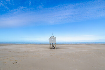 A wooden shelter on high stilts that stands on the North Sea beach (De Drenkelingenhuisje) The...