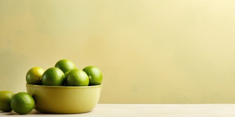 Bowl of Green Limes on Table with Yellow Background. Citrus Fruit, Fresh Exotic Food. Generative AI