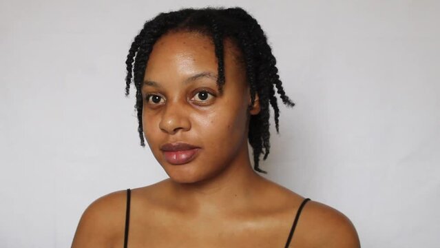 Black woman with twists on her natural 4c hair on a white background