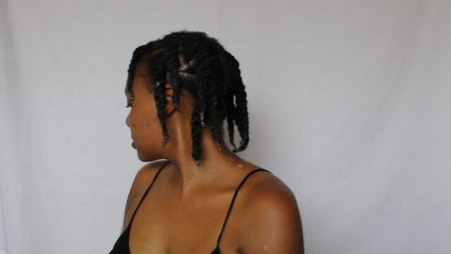 Black woman with twists on her natural 4c hair on a white background