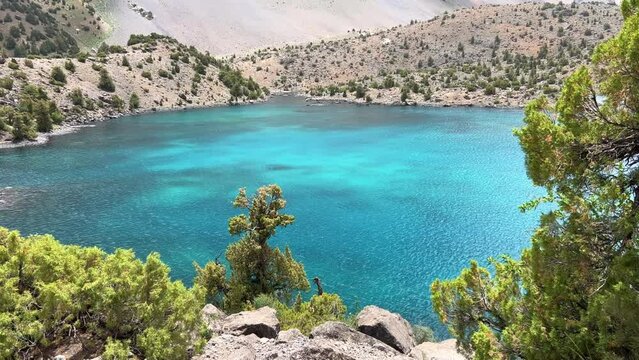 The Alaudin (Chapdara) lakes, lying at an altitude of 2800 m, are considered one of the most beautiful lakes of the Fan Mountains. Turquoise mountain lake. Pamiro-Alai. Tajikistan, Pamir 4K