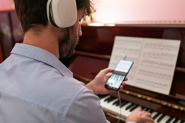 Man Making Remote Music Piano Lesson With Phone Connection
