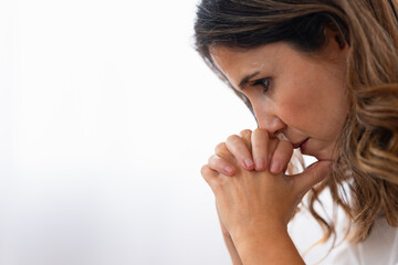 Photo with copy space and close-up of a sad woman thinking looking down