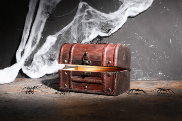 Old treasure chest with Halloween decor on dark background