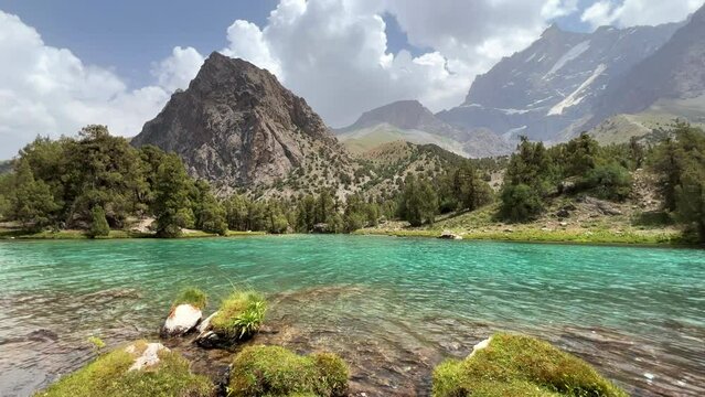 The Alaudin (Chapdara) lakes, lying at an altitude of 2800 m, are considered one of the most beautiful lakes of the Fan Mountains. Turquoise mountain lake. Pamiro-Alai. Tajikistan, Pamir 4K
