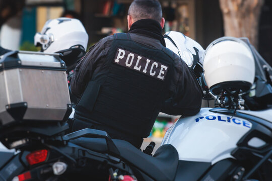 Fototapeta Hellenic Police, Greek police squad on duty riding bike and motorcycle, maintain public order in the streets of Athens, Attica, Greece, group of policemen with "Greek Police" logo emblem on uniform
