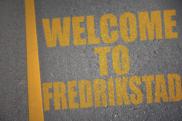 asphalt road with text welcome to Fredrikstad near yellow line. - obrazy, fototapety, plakaty