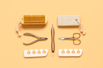 Set of professional tools for pedicure on orange background