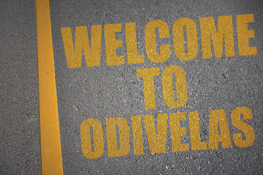asphalt road with text welcome to Odivelas near yellow line.