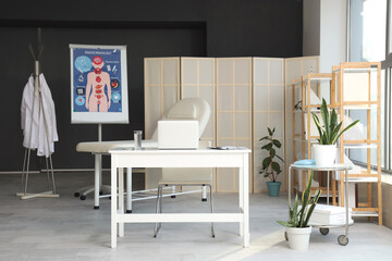 Interior of medical office with workplace and folding screen