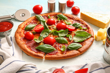 Delicious Pepperoni pizza with tomatoes and basil on light blue background