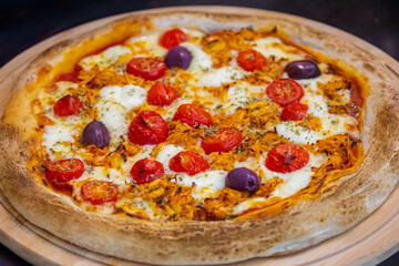 Traditional Brazilian chicken pizza with catupiry cheese, long-aged dough baked on a stone