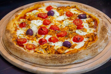 Traditional Brazilian chicken pizza with catupiry cheese, long-aged dough baked on a stone