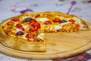 Traditional Brazilian chicken pizza with catupiry cheese, long-aged dough baked on a stone