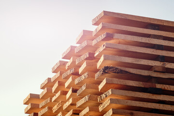 Wood timber stack of wooden blanks construction material. Piles of wooden boards in sawmill. Warehouse for sawing boards