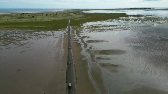 road to Lindisfarne Castle on the Northumberland coast, England. aerial view