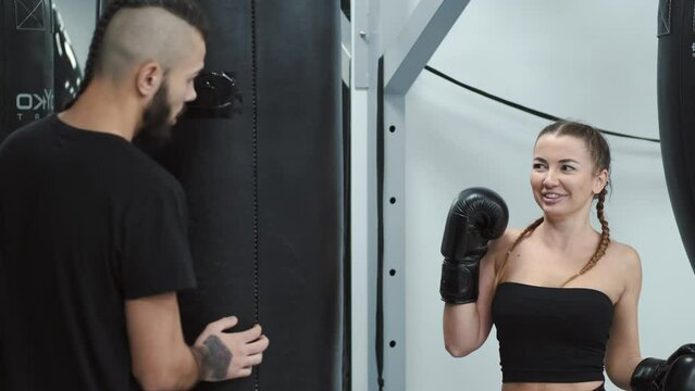 girl training with her brother improving her technique and skill in boxing, getting ready for the compition